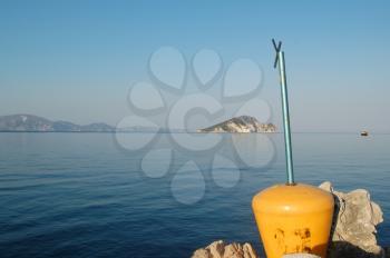 Marathonisi islet as seen from a pier on Keri Beach in the bay of Laganas. Zakynthos, Greece.