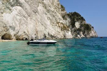 Motorboat anchored on remote beach in Zakynthos, Greece.