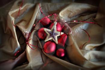 Red baubles and golden star. Christmas ornaments background.