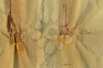 Weathered piece of paper with rust stains. Abstract grunge background.