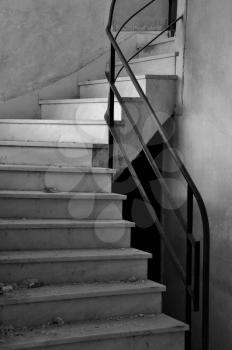 Dirty marble staircase in abandoned interior. Architectural detail, black and white.