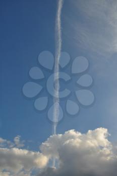 Blue sky airplane smoke trail and clouds. Abstract travel background.