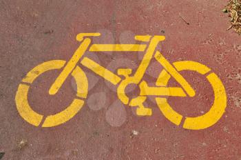 Bicycle sign stencil on bike lane abstract sports background.