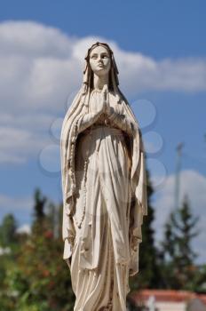 Virgin Mary hands joined in prayer marble funerary statue.