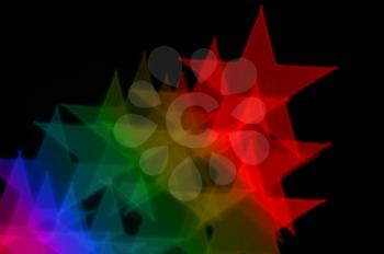 Colorful stars on black background abstract blurry lights.