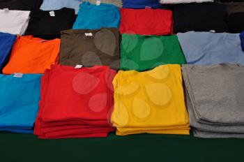Cotton short sleeve t-shirts folded colorful clothes background.
