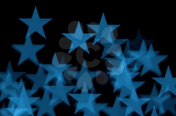 Blue stars pattern abstract blur on black background.