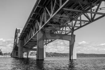 A view from under the I-90 bridge in Seattle, Washington. Black and white image.