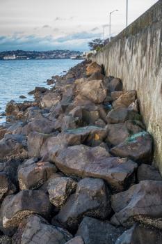 A view of boulders along a sea wall in West Seattle, Washington.