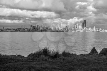 Billowing clouds hover over the Seattle skyline. Black and white image.