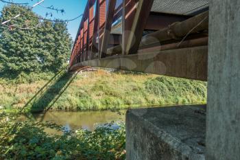 A metal walking bridge spans the Green River in Washington State. Closeup shot.