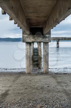 A view from beneath the pier at Dash Point, Washington. The tide is low.