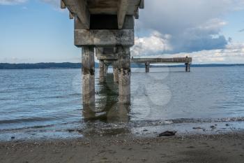 Pilings encrusted with barnacles are revealed at low tide. Location is Dash Point Washington in the Pacific Nortwest.