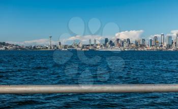 A view of the Seattle skyline with a railing in the forefround.