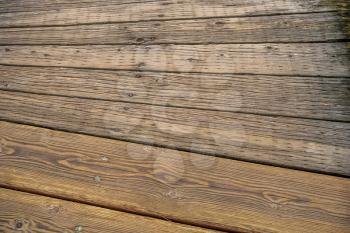 Closeup of curving wood planks on a walkway.