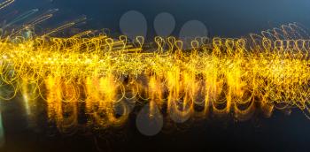 Lights at the Des Moines Marina make abstract waves. Shot taken at slow shutter speed with a flip of the wrist.
