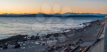 A silhouette of the Olympic Mountains at sunset.  Panoramic shot.