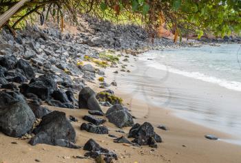 A view of lava rocks on a a shoreline in Maui, Hawaii.
