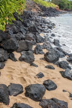 A view of rocks on the shoreline in the Kahana area of Maui, Hawaii.