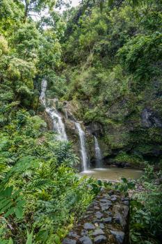 A waterfall flows into a pool on the road to Hana on Maui, Hawaii.