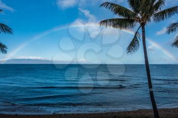 A view of a rainbow over the ocean in Maui, Hawaii.