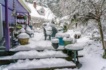 The back porch of a home in Burien, Washington is buried in snow.