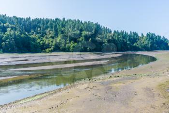 The Nisqually River flows past mud flats in the Nisqually Wetlands near Olympia, Washington.