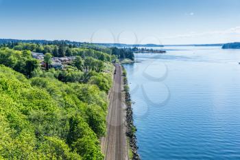 Train tracks run along the shore  of the Tacoma Narrows waterway.