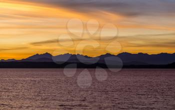 A silhouette shot of a sunset over the Olympic Mountains in Washington State.