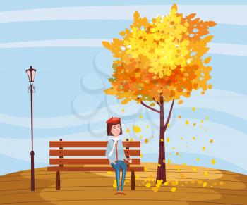 Autumn, happy girl sitting on a bench with a cup of coffee, under a tree with falling leaves