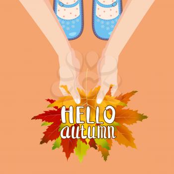 Women blue shoes on autumn leaves. Hands holding autumn leaves. Lettering Hello Autumn