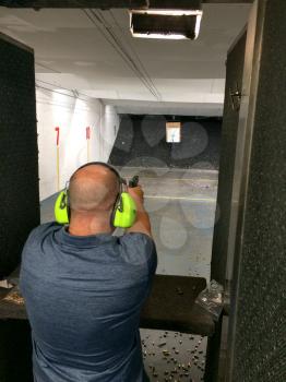 Fireams training handgun at indoor range vertical