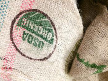 Burlap coffee bean bags on floor with organic imported coffee