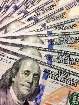 American one hundred dollar bills with Benjamin Franklin vertical