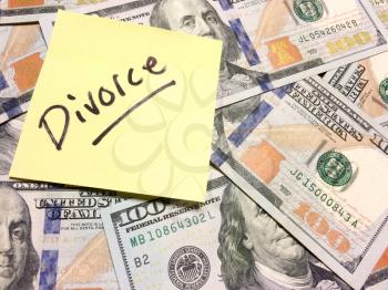 American cash money and yellow post it note with text Divorce in black color aerial view