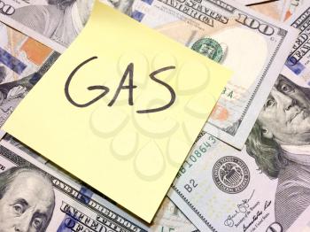 American cash money and yellow paper note with text Gas in black color aerial view