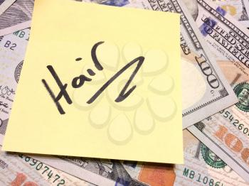American cash money and yellow sticky note with text Hair in black color aerial view