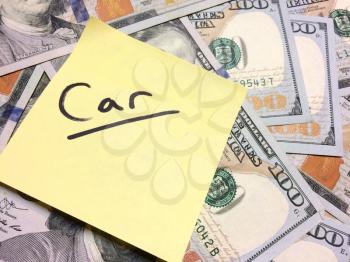 American cash money and yellow sticky note with text Car in black color aerial view