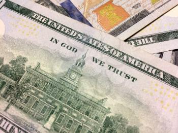 Text of In God We Trust on American cash money with Independence Hall Philadelphia