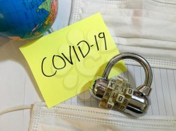 China virus Coronavirus COVID-19 infection lock down COVID respiratory disease influenza effect on surgical mask and earth globe background