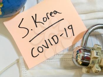 China virus Coronavirus COVID-19 infection South Korea lock down COVID respiratory disease influenza effect on surgical mask and earth globe background