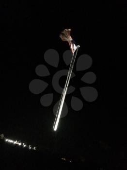 American flag on flag pole motion background at night with lights