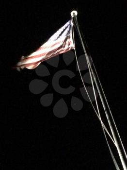 American flag on flagpole motion background black at night with spotlight