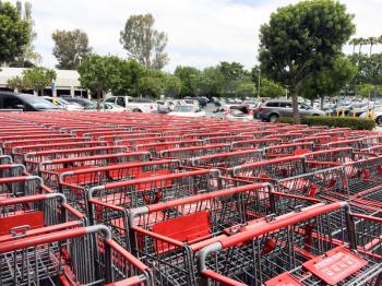 red and silver metal shopping carts organized in mass rows making square patterns