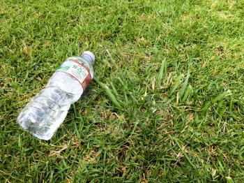 Plastic water bottle close up on green grass nature environment concept for recycling
