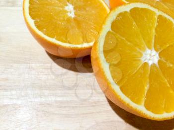 Oranges sliced on wooden cutting board fresh juicy round and ripe