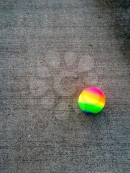 Colorful rubber ball on concerte playground floor bouncing