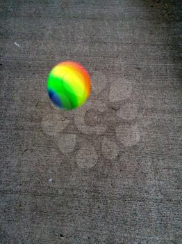Colorful rubber ball on concerte playground floor bouncing