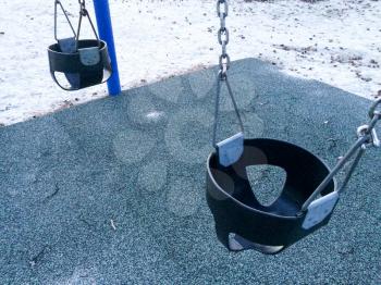 Empty swing at playground for baby and toddler saftey seat