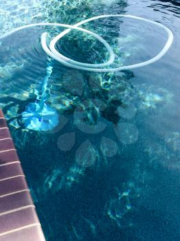 Swimmimg pool automatic cleaner skimmer with hose and blue water reflections design